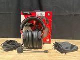 the headphones are sitting on a wooden table with a black bag