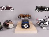 a lot of different model cars and motorcycles on display
