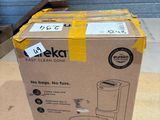 packaging of a boxed coffee maker sitting on top of a wooden floor