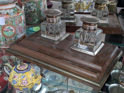 many different vases and jars on display on a glass table