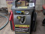 une photo d'un compresseur d'air portable dans un garage