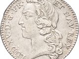 a silver coin with a woman ' s head on it