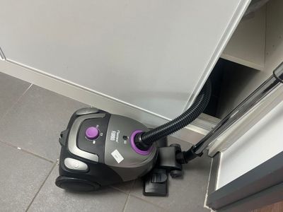 a vacuum that is sitting on the floor next to a door