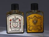 two bottles of cologne sitting on a shelf next to each other