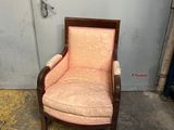 an old chair with a pink upholstered upholstered seat