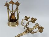 two antique brass objects including a clock, a candle holder, and a pair of scissors