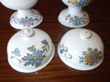 three white bowls with blue and yellow flowers on them