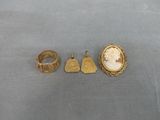 three gold rings and a ring with a picture of a woman
