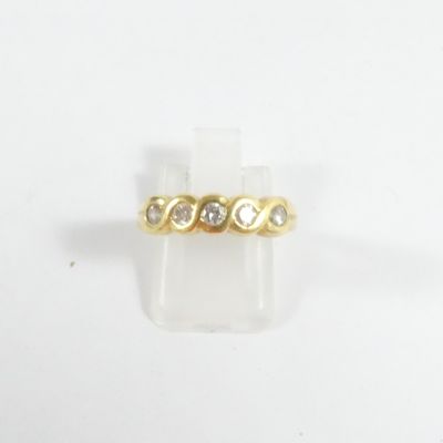 gros plan d'une bague en or ornée de trois diamants