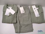 two pairs of men ' s pants with tags on them