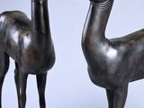 pair of bronze statues of a deer and a goat on a marble base