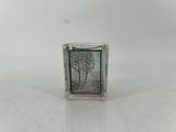 a small glass block with a picture of a tree on it