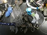 many different types of jewelry on a black table
