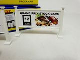 a sign that says grand prix stock cars next to a box of pills