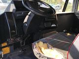 a seat in the back of a truck with a bag in it