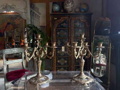 three candles that are sitting on a table in a room