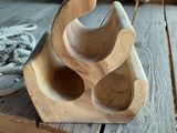 a wooden object that is sitting on a wooden floor