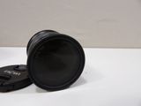 the camera lens is sitting on the table next to the lens cap