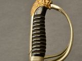 an old sword with a gold handle and a lion head on it