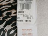 a label on the back of a dress with a zebra print pattern