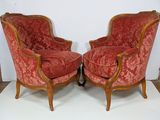 pair of red upholstered chairs on a white surface