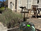 a glass vase sitting on the steps outside of a house