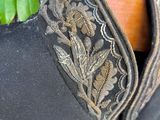 a close up of a black jacket with gold embroidery on it