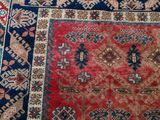 rug on the floor is red and blue with a pattern on it