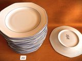 a stack of plates sitting on a table next to a bowl