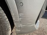 a close up of a car ' s bumper with a hole in it
