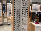 a display of glasses in a store with a lot of them