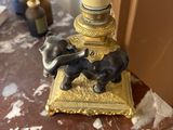 a lamp that is sitting on a table with a dog figurine on it
