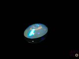 an image of a white oplite in the dark