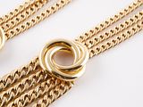 two gold chains with a knot on each end and a ring on the end