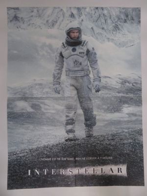 poster of a man in a space suit standing in front of a mountain
