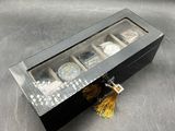 a close up of a watch in a box on a table