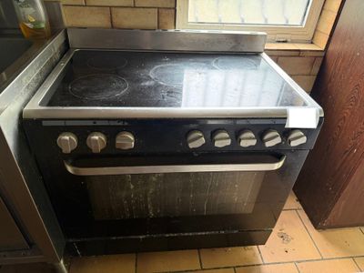 a stove that is in a kitchen with a window