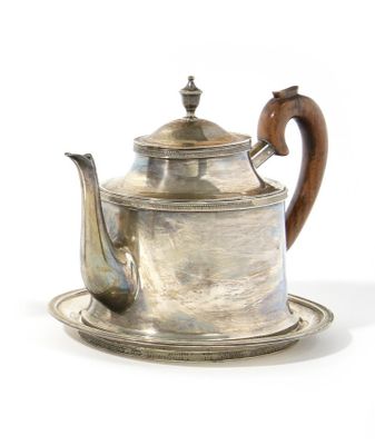 a silver tea pot with a wooden handle on a silver plate