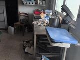 a messy kitchen with a lot of clutter on the floor
