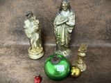 deux statues de Jésus et un vase vert posés par terre