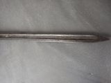 a metal spoon that is laying on top of a table