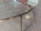 a glass coffee table with a metal frame on the top