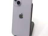 an iphone is sitting on top of a stand on a white surface