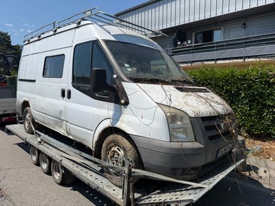 a white van that is being towed by a flatbed truck