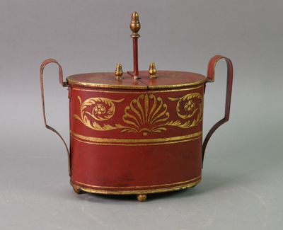 a red and gold box with a handle on it