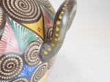 a colorful vase that is sitting on a table
