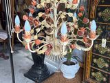 a chandelier that has a bunch of flowers on it