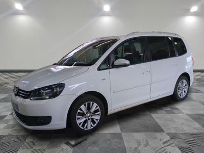 the white van is parked on a checkered floor in the garage