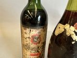 two bottles of wine sitting next to each other on a table