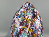 a glass vase with a lot of different colors on it